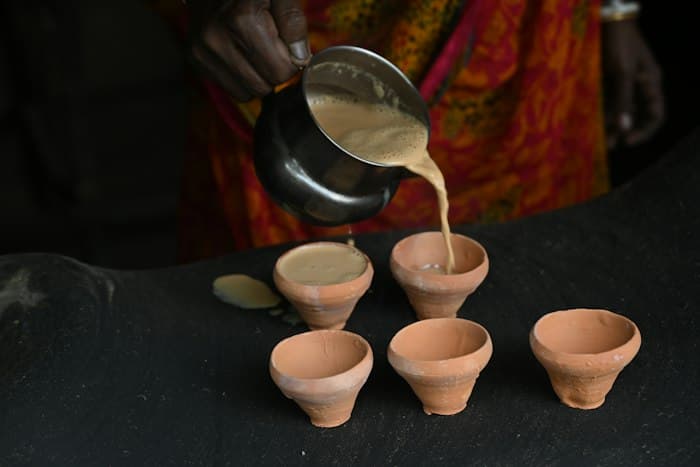 Chai poured into clay kulhads