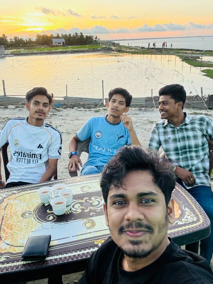 Friends sharing chai by the water